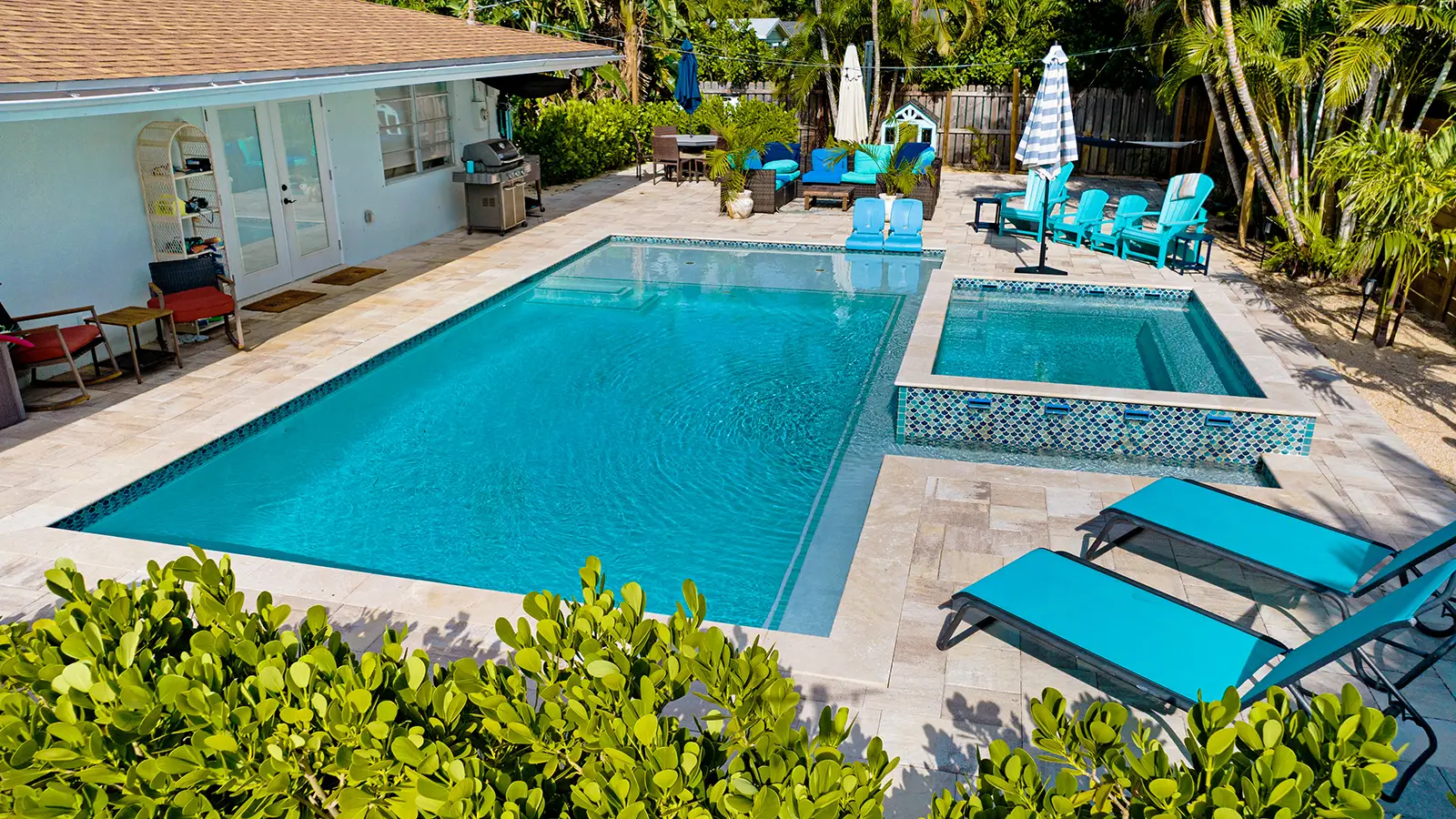 A tropical backyard with a beautiful swimming pool