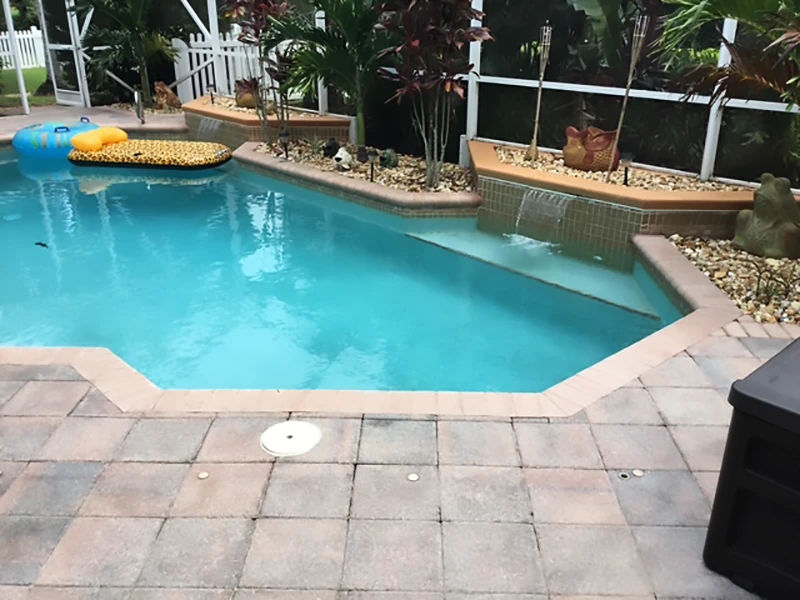 Swimming pool with tropical landscaping.
