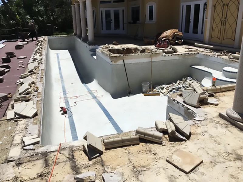 Empty pool under construction with debris