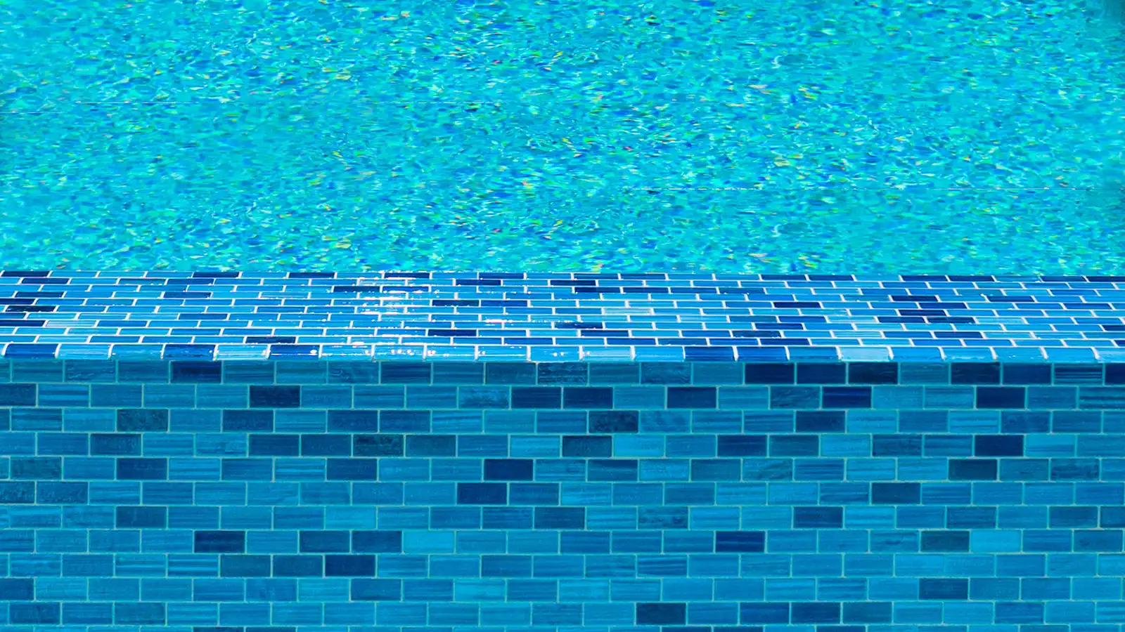 Blue swimming pool water and custom tile