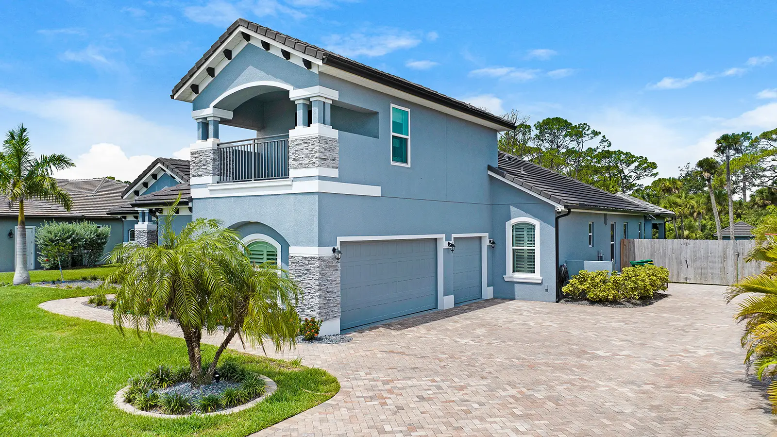 A modern home with a custom paved driveway