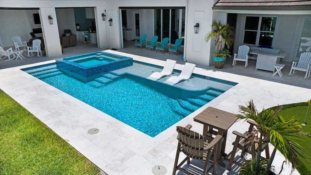 A home backyard and patio with a swimming pool