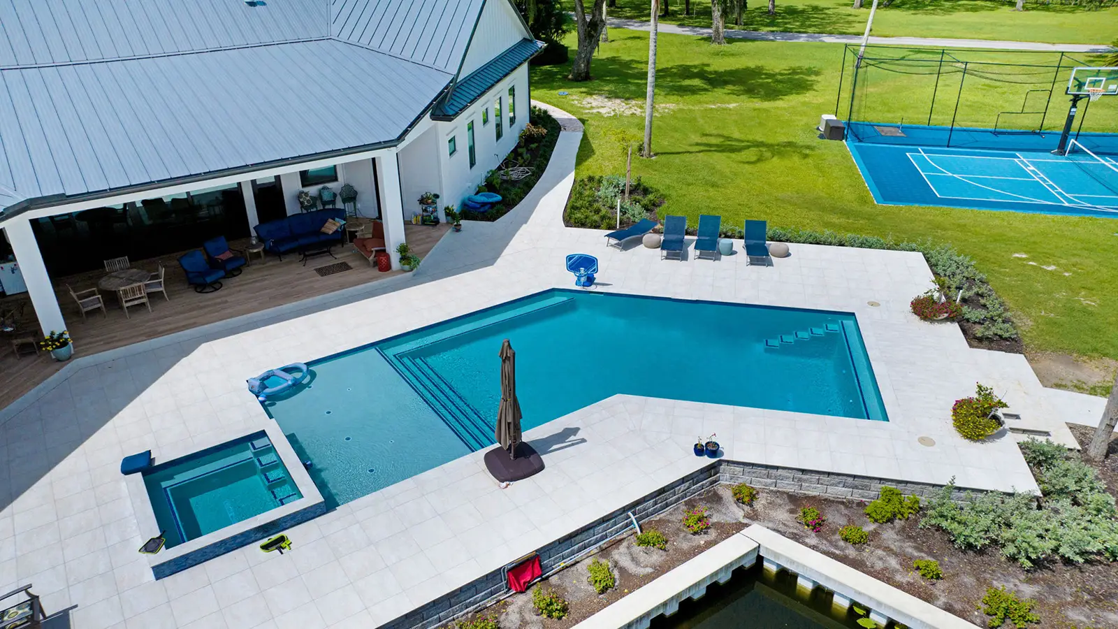 A luxury home with a swimming pool and pickleball court