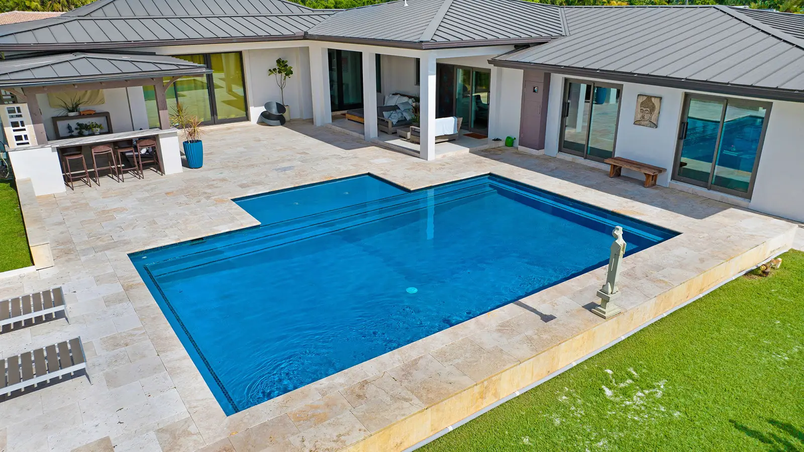 A brand new swimming pool with custom patio pavers