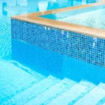 A new swimming pool with clear water and custom tile work