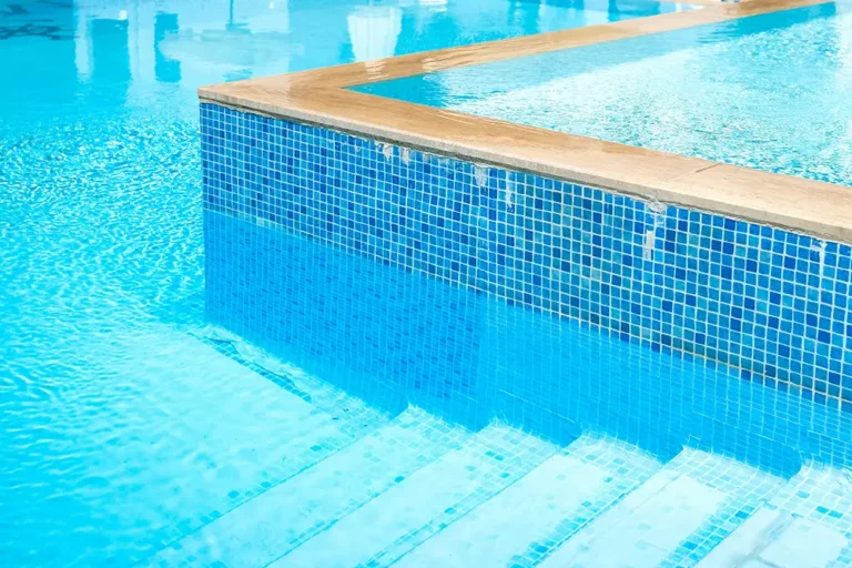 A new swimming pool with clear water and custom tile work