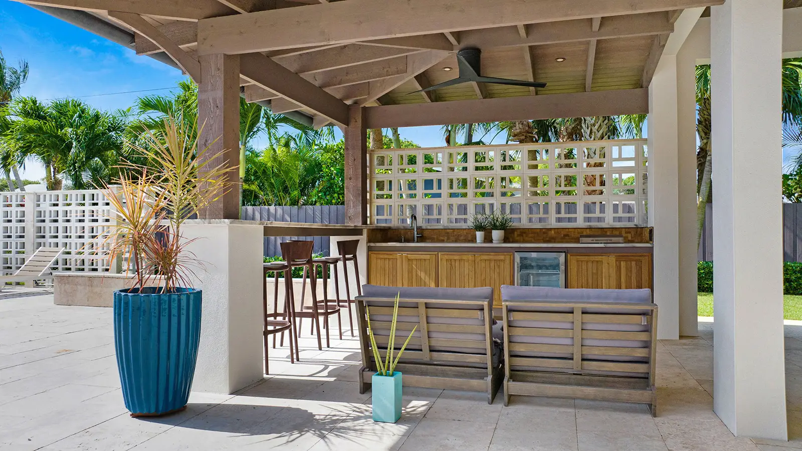 A custom built outdoor kitchen with palm trees in the background