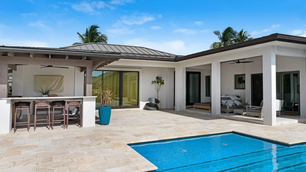 A modern home in Florida with a beautiful patio and pool