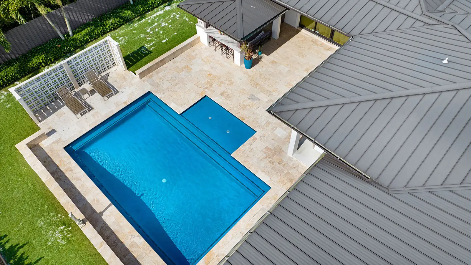 Aerial photo of a blue swimming pool and patio