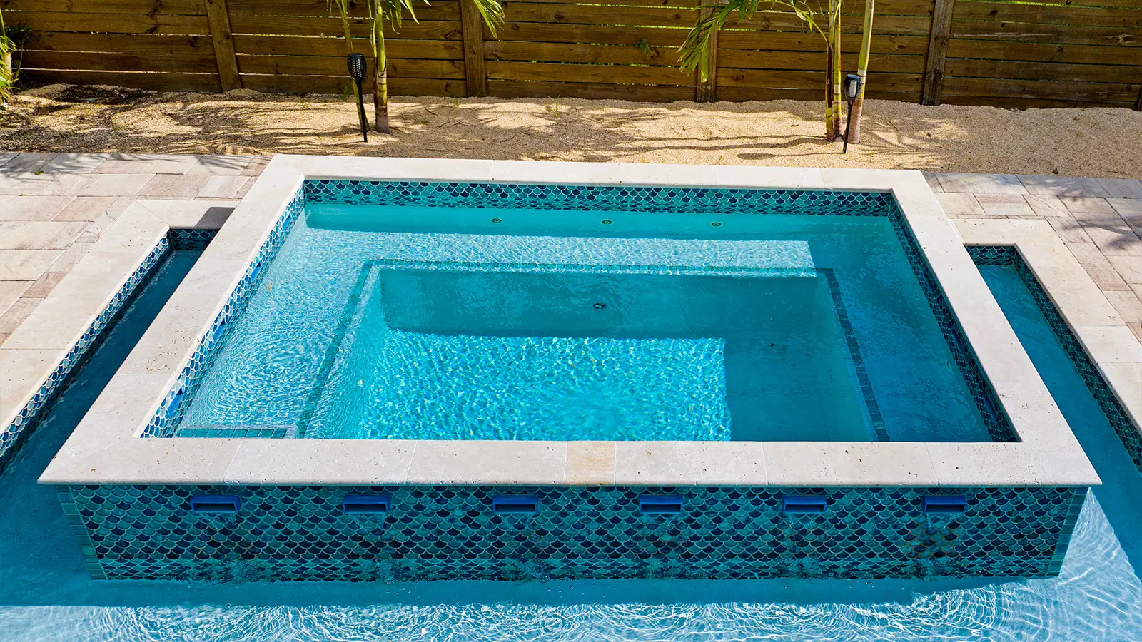 A pool spa with waterfall fountains