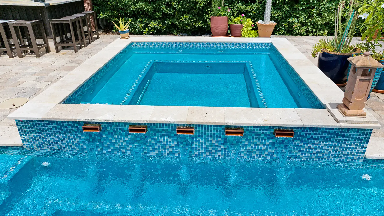 Swimming pool with waterfall fountains